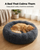 Cat asleep in the medium dark grey calming plush donut bed