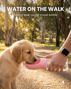 Puppy drinking from the pink 550ml portable pet water bottle